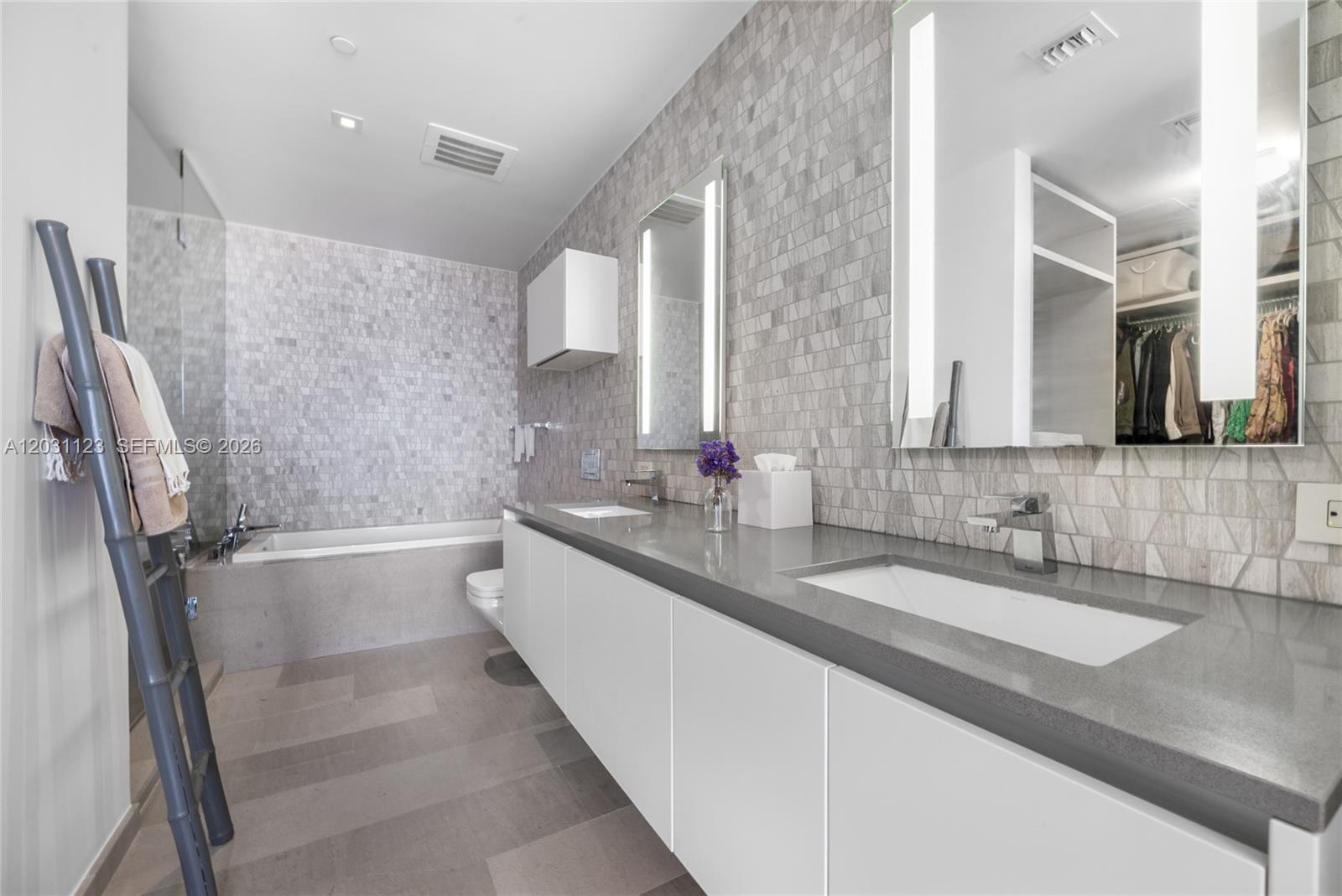 88 Southwest 7th Street, Unit 3208 Miami, FL 33130 - Photo 5 of 16 a bathroom with double vanity and a bathtub