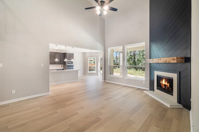 a view of an empty room with a fireplace and a window