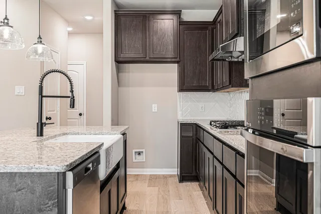 a kitchen with granite countertop a stove and a sink