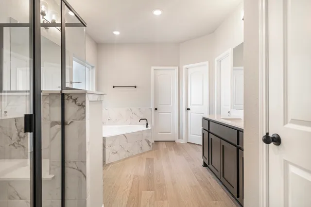 a bathroom with a bathtub and a shower