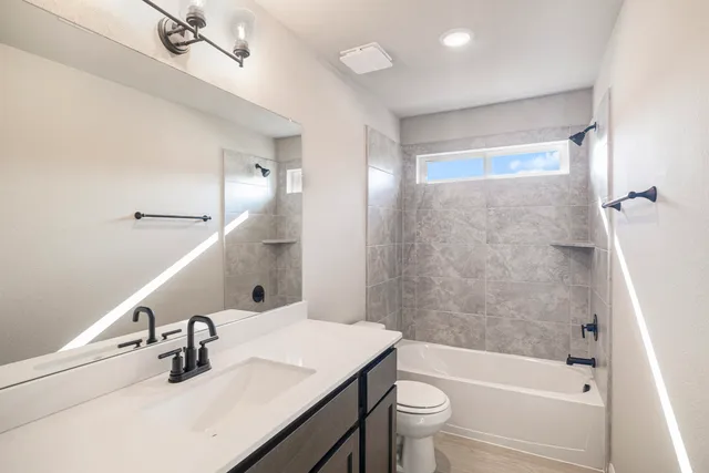 a bathroom with a sink a toilet and a bathtub