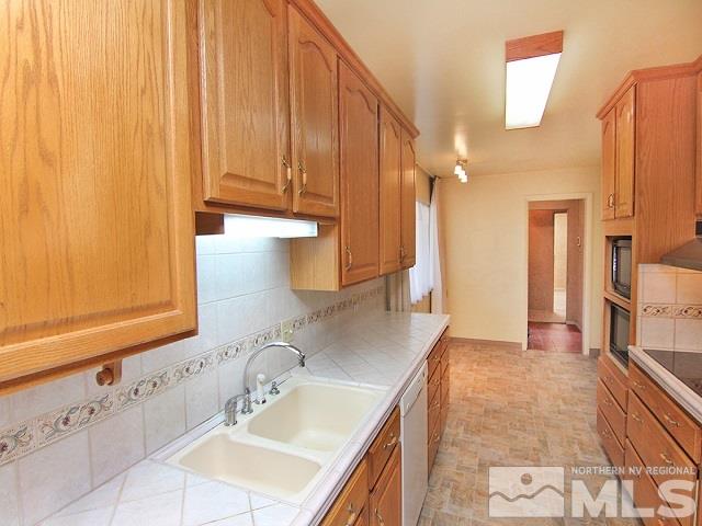 810 West 12th Street Reno, NV 89503 - Photo 3 of 25 a bathroom with a sink a mirror and a shower