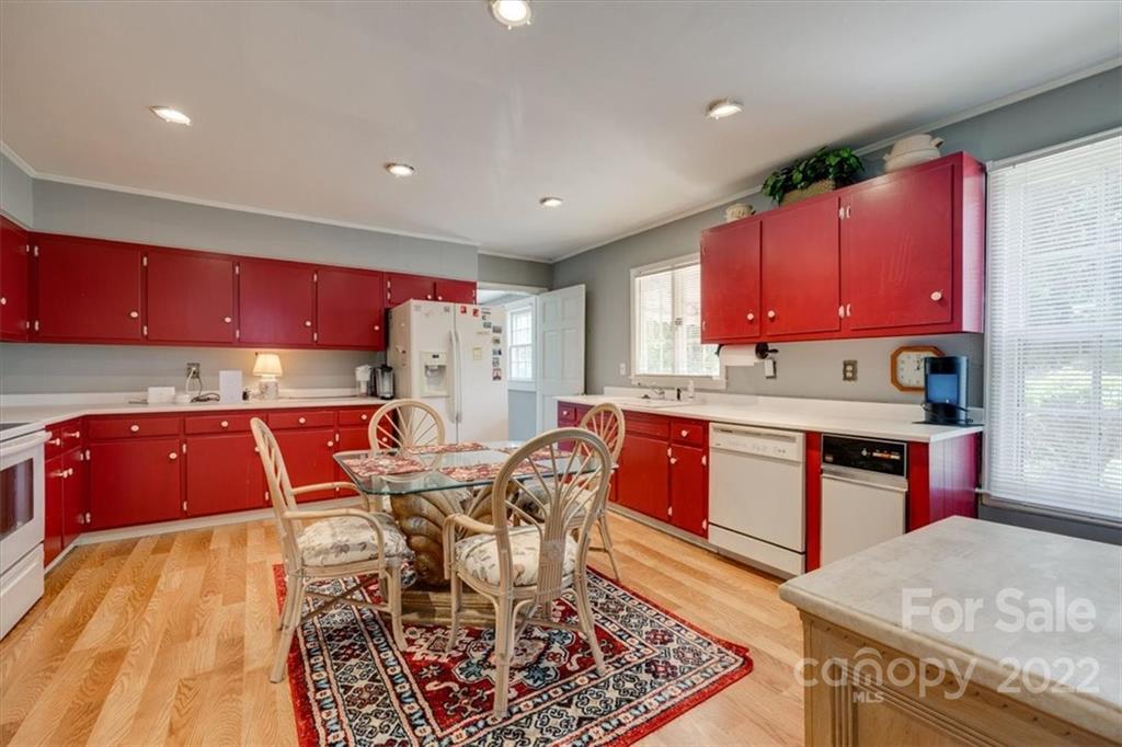 204 West South Street Union, SC 29379 - Photo 15 of 38 a kitchen with stainless steel appliances granite countertop a stove top oven a refrigerator and red chairs
