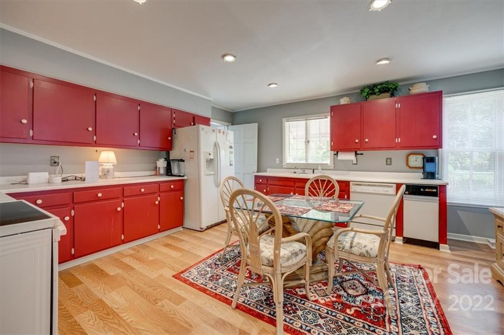 204 West South Street Union, SC 29379 - Photo 17 of 38 a kitchen with stainless steel appliances kitchen island granite countertop a dining table chairs and a refrigerator