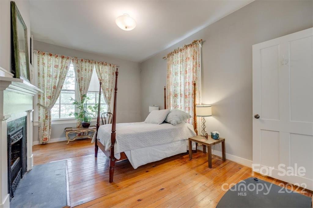 204 West South Street Union, SC 29379 - Photo 28 of 38 a bedroom with a bed and a fireplace