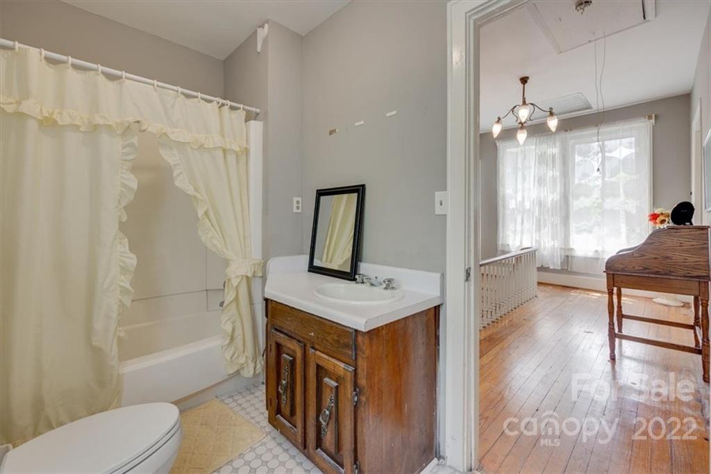 204 West South Street Union, SC 29379 - Photo 30 of 38 a spacious bathroom with a granite countertop sink a toilet a mirror and shower