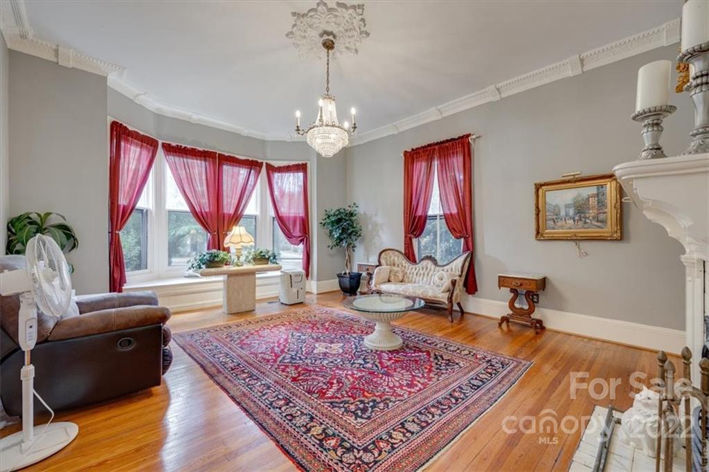 204 West South Street Union, SC 29379 - Photo 5 of 38 a living room with furniture a rug and a chandelier