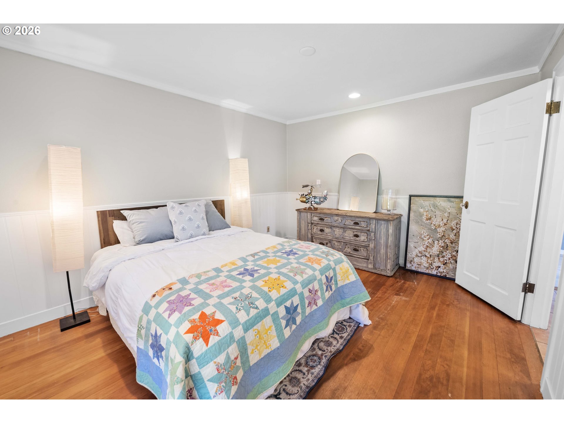 3232 Sunset Boulevard Seaside, OR 97138 - Photo 34 of 48 a bedroom with a bed a mirror on dresser and a table