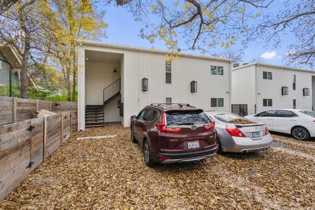a car parked in front of white house