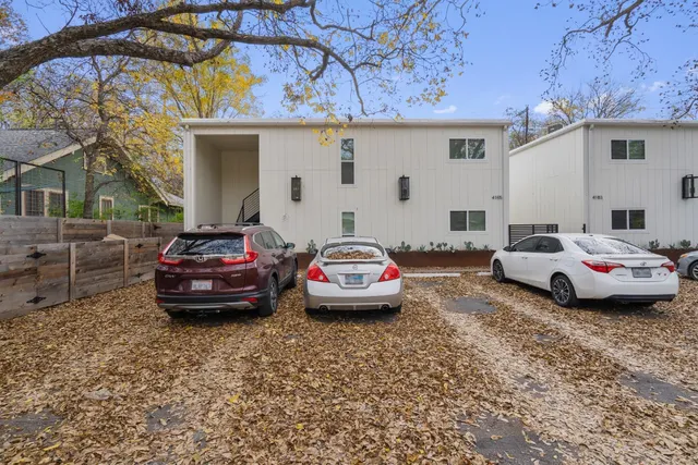 a car parked in front of white house