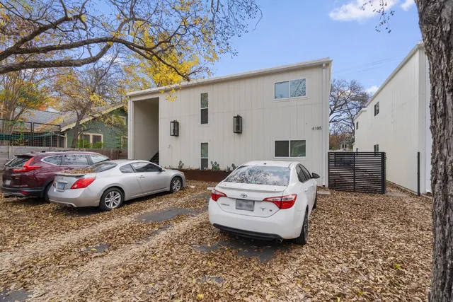 a car parked in front of white house