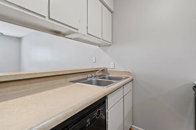 a utility room with sink and washing machine