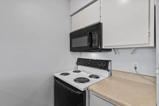 a kitchen with a stove and a microwave