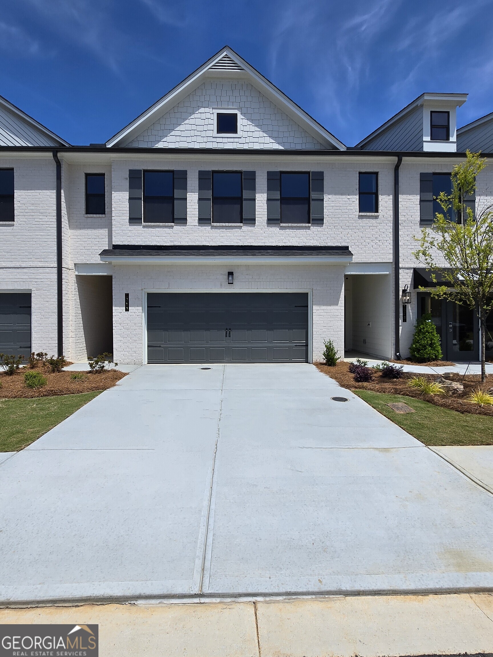 1299 Farmers Loop Austell, GA 30106 - Photo 1 of 23 a front view of a house with a yard and garage