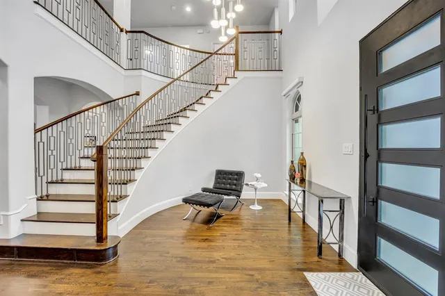 a view of entryway and hall with wooden floor