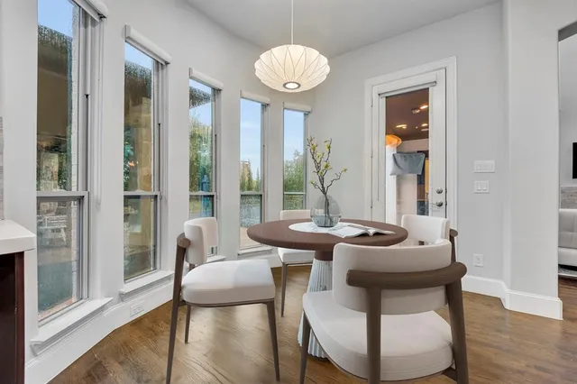 a dining room with furniture and wooden floor
