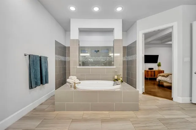 a spacious bathroom with a large tub and shower