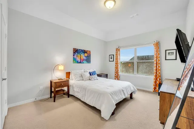 a bedroom with a bed and a dresser next to it