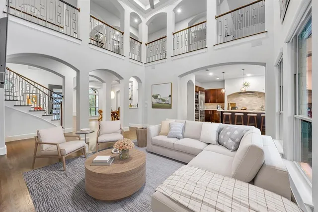 a living room with furniture and kitchen view