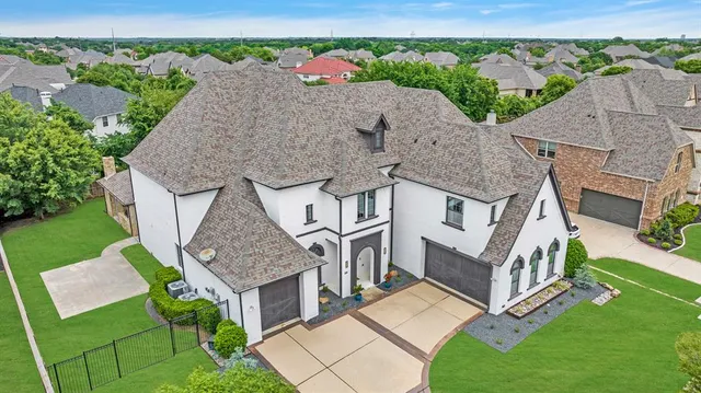 an aerial view of a house with a yard and garage
