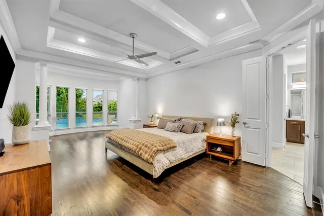 a spacious bedroom with a bed and large windows