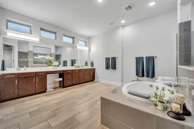 a large bathroom with double vanity and a sink