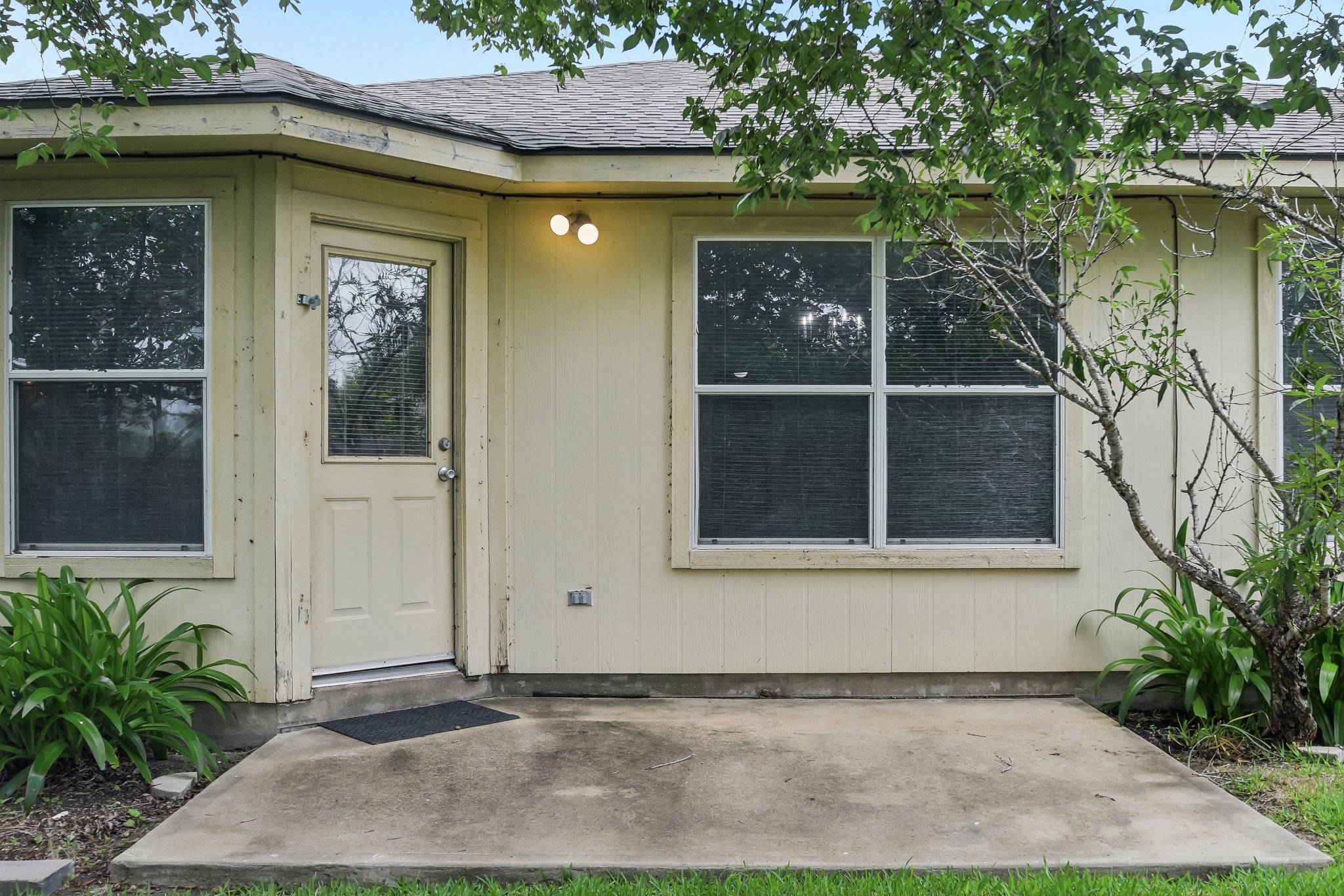 610 Lavaca Loop Elgin, TX 78621 - Photo 32 of 37 A modest rear entry and concrete patio offer a secluded outdoor space.