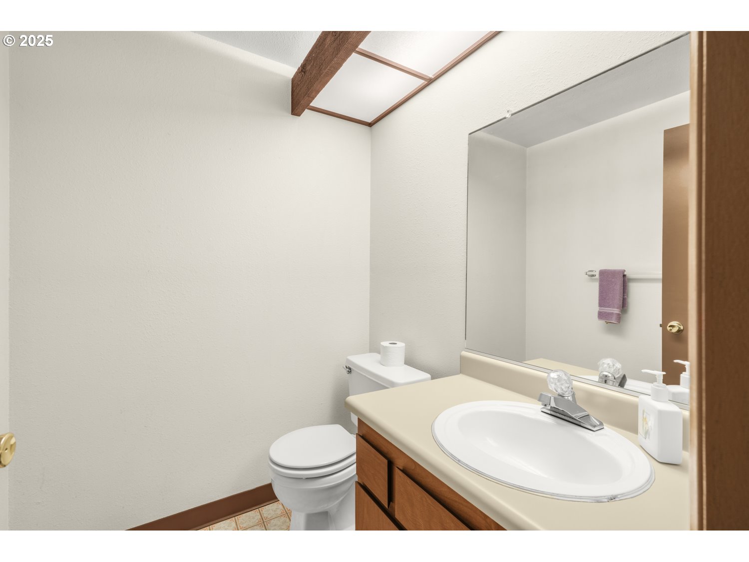 650 Southwest Meadow Drive, Unit 218 Beaverton, OR 97006 - Photo 18 of 25 a bathroom with a sink a toilet and mirror