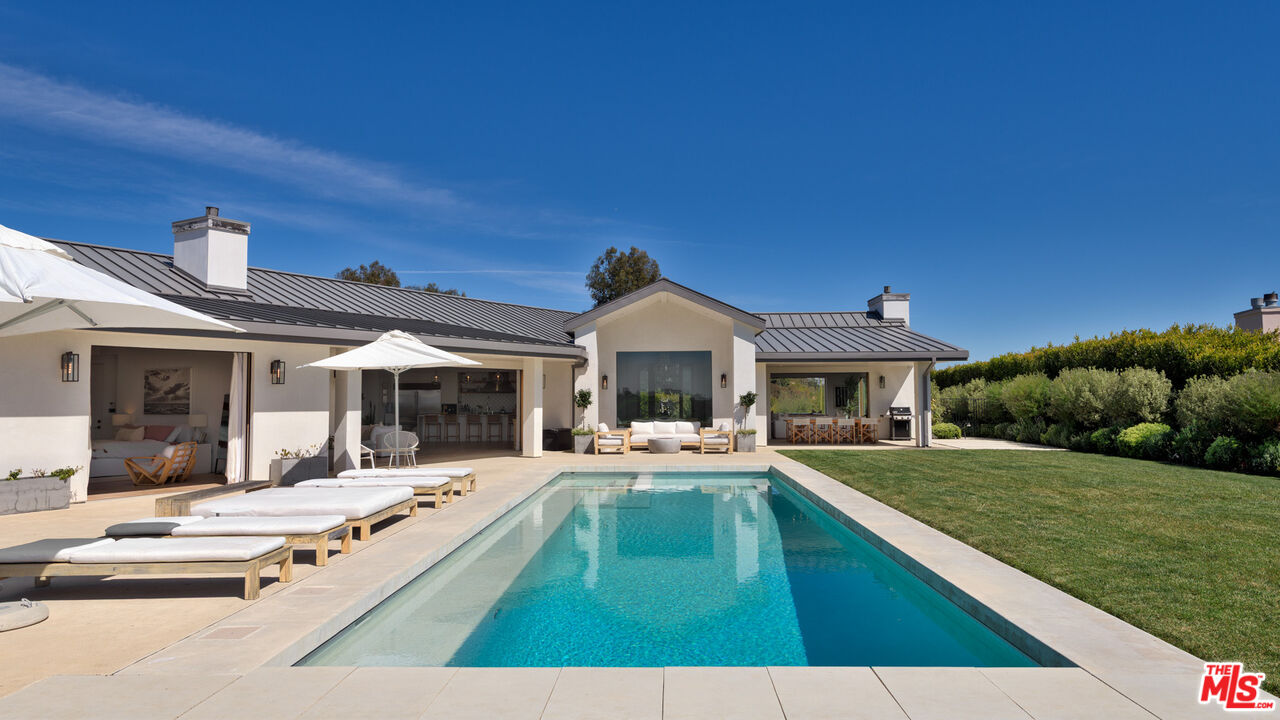 6245 Murphy Way Malibu, CA 90265 - Photo 1 of 2 a swimming pool view with a seating space and a garden view