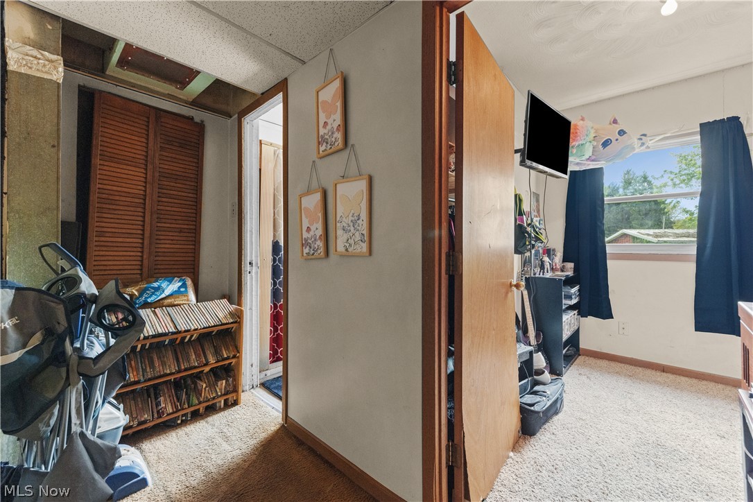 68-70 East Sunset Drive Rittman, OH 44270 - Photo 45 of 49 Interior space with wood-finish louvered doors, light-colored walls, and textured carpeting