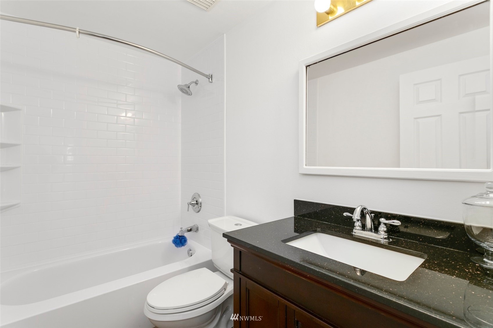 20605 Southeast 159th Street Renton, WA 98059 - Photo 13 of 40 a bathroom with a granite countertop sink toilet a mirror and shower
