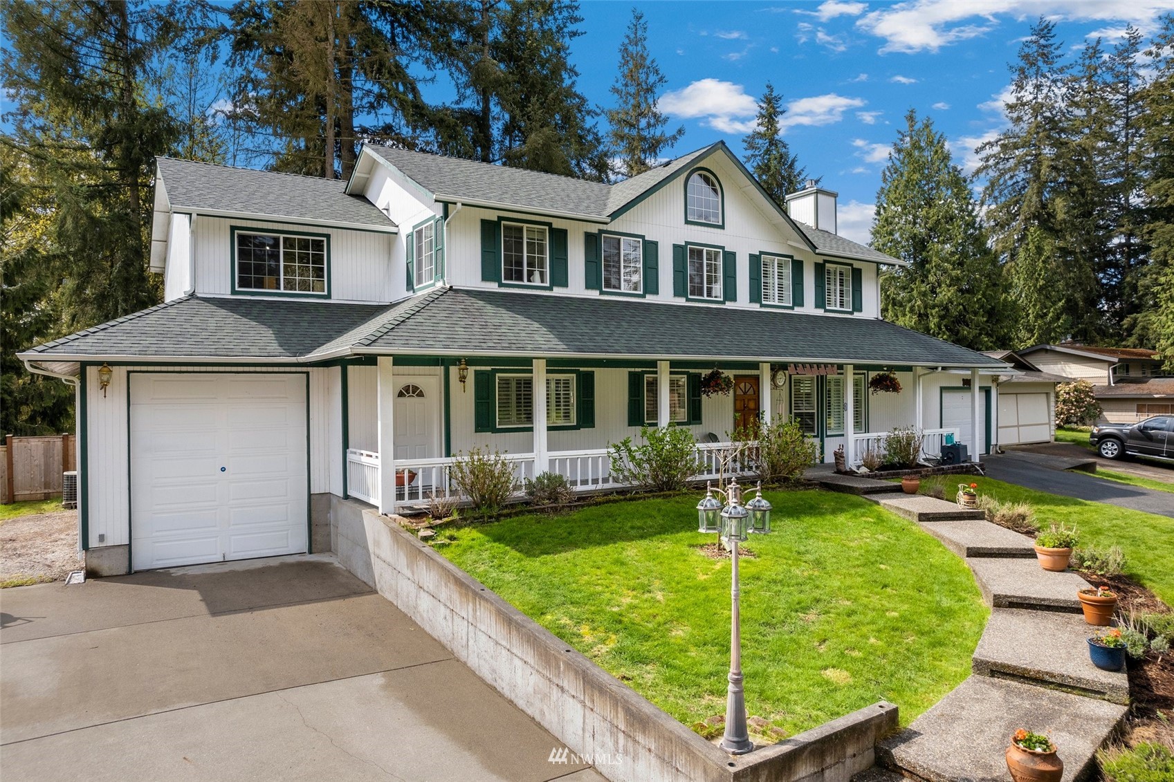 20605 Southeast 159th Street Renton, WA 98059 - Photo 2 of 40 a front view of a house with a yard table and chairs