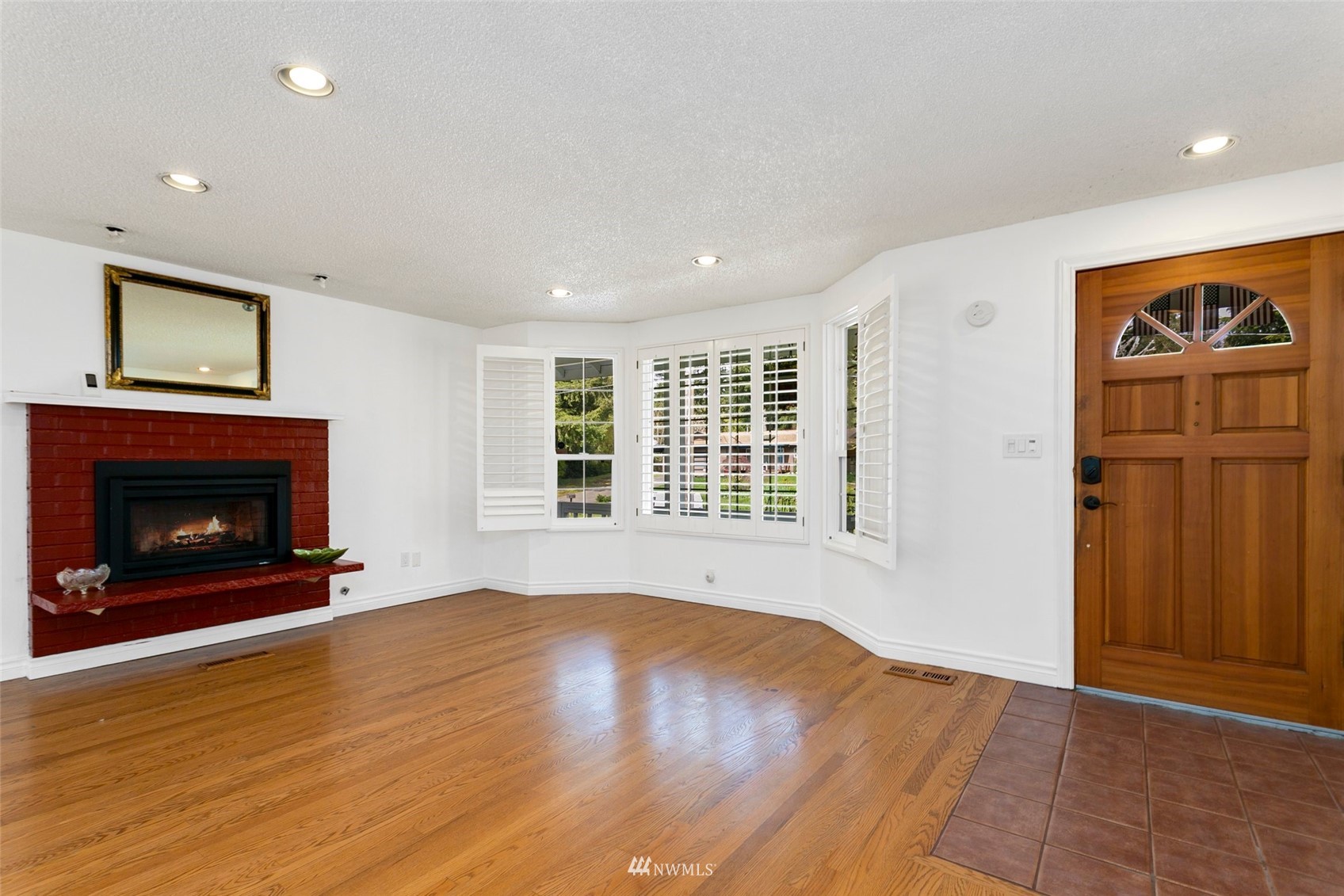20605 Southeast 159th Street Renton, WA 98059 - Photo 5 of 40 a view of an empty room with a window and fireplace