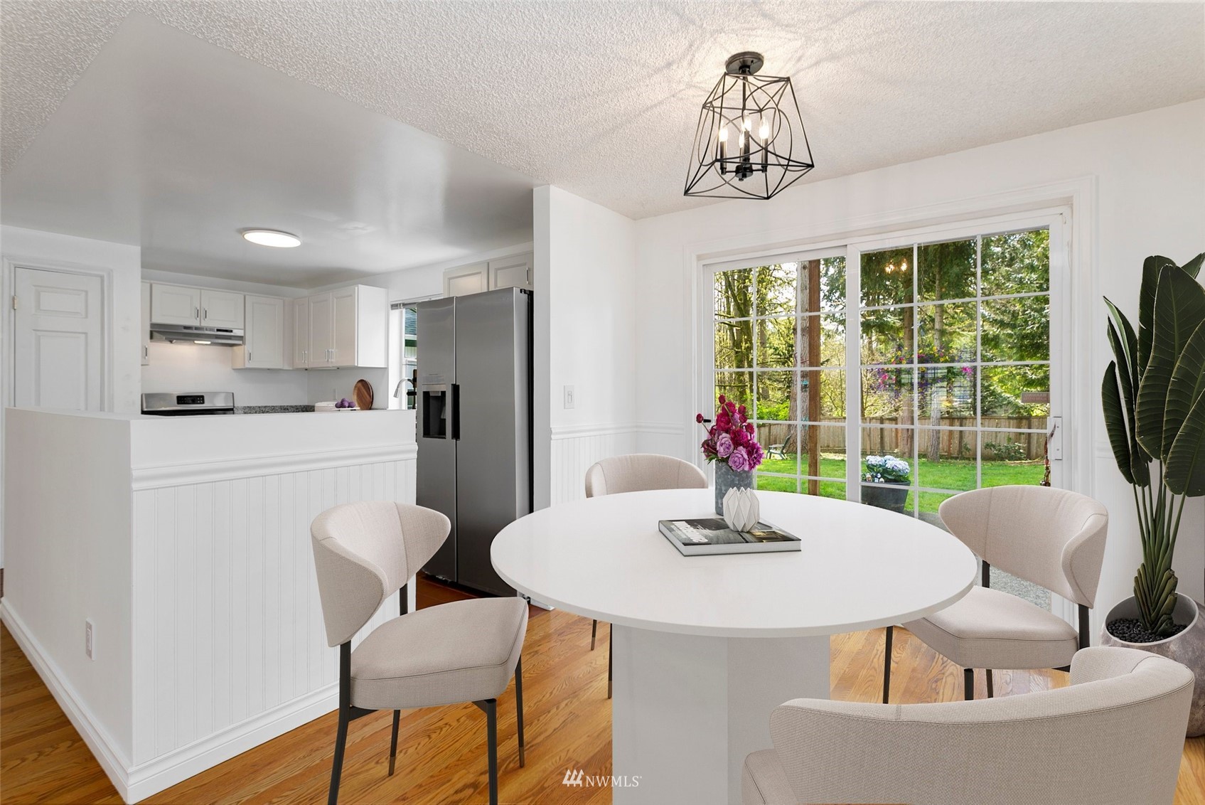 20605 Southeast 159th Street Renton, WA 98059 - Photo 8 of 40 a kitchen with a dining table chairs and a refrigerator