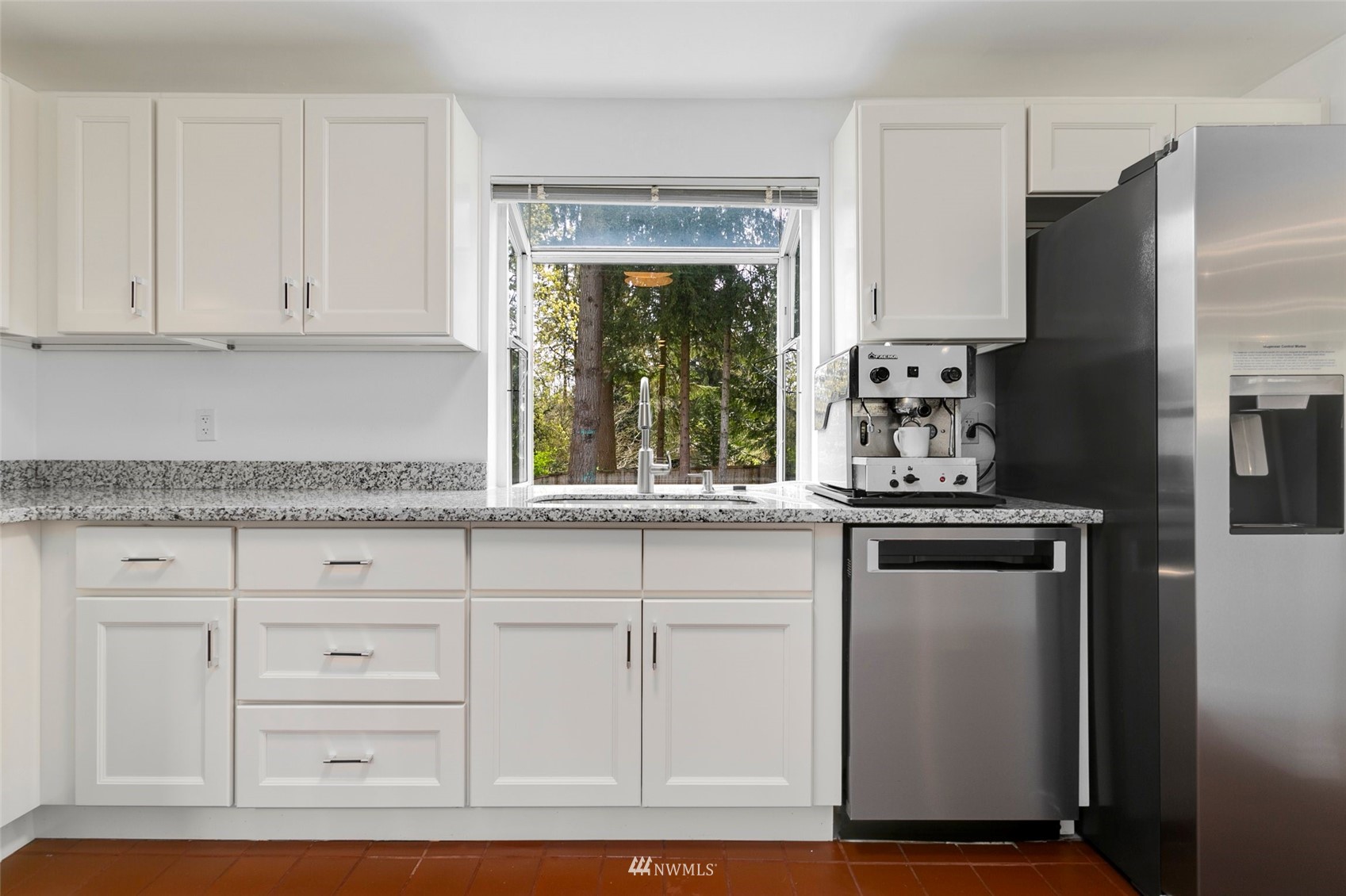 20605 Southeast 159th Street Renton, WA 98059 - Photo 9 of 40 a kitchen with granite countertop white cabinets and stainless steel appliances