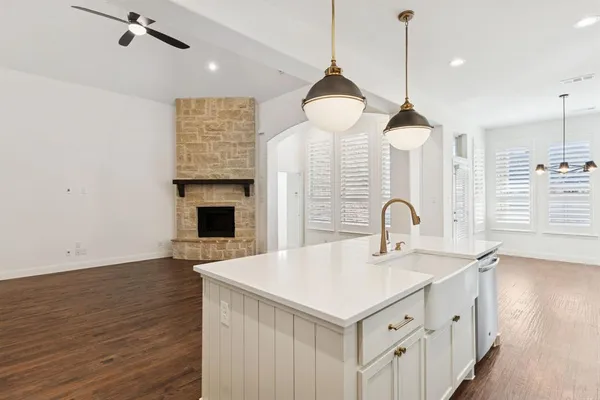a kitchen with a sink chandelier and a stove