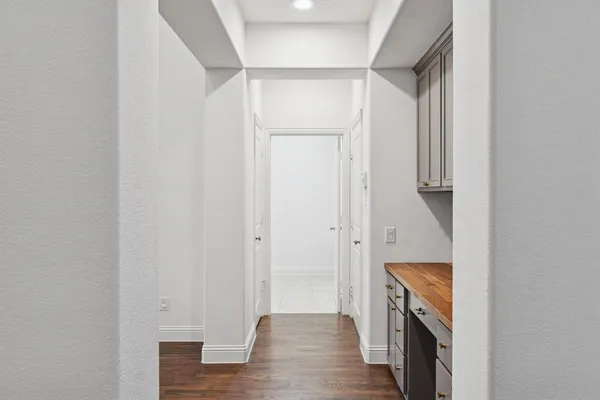 a view of walk in closet with wooden floor