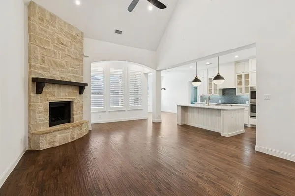 a view of an empty room with a fireplace and a window
