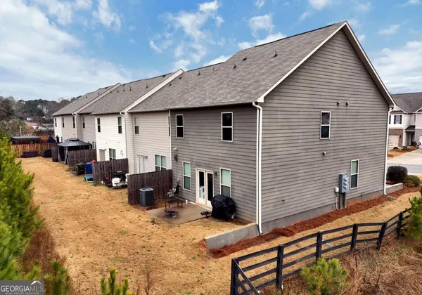 a backyard of a house with yard and sofas