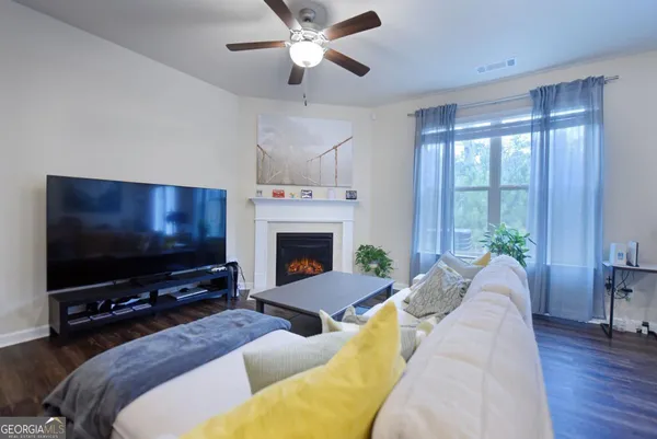 a living room with furniture and a flat screen tv