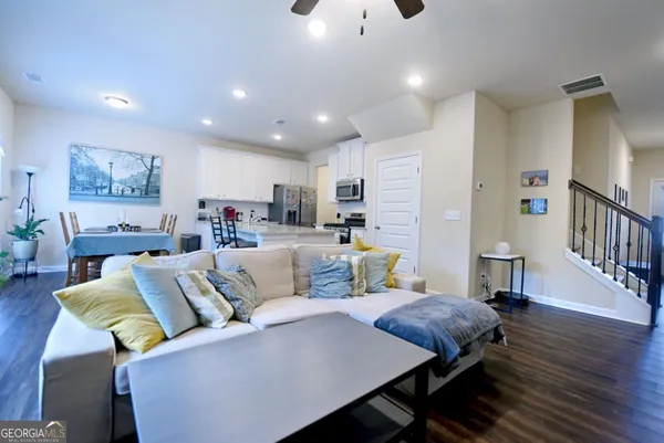 a living room with furniture and a wooden floor