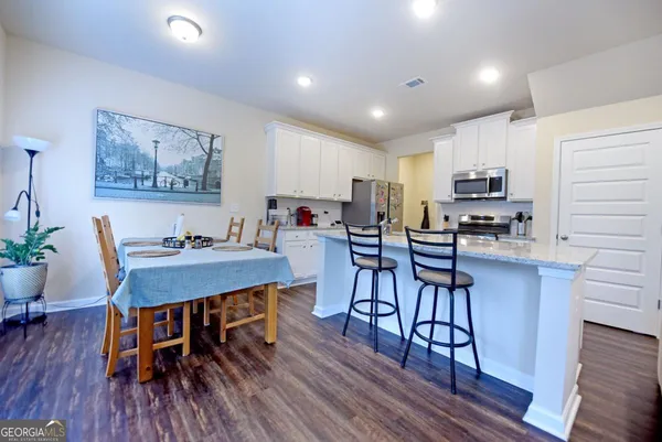 a view of a dining room with furniture and wooden floor