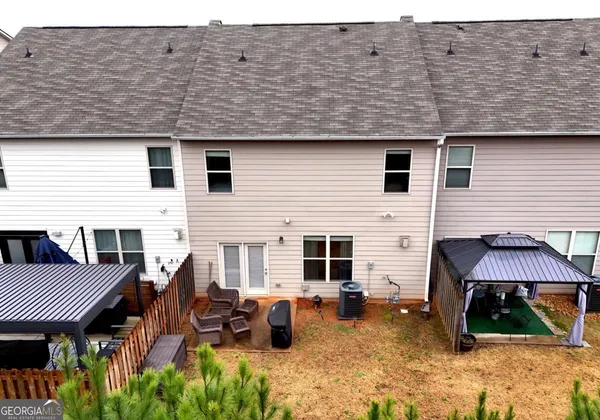 a view of a patio with a table and chairs under an umbrella
