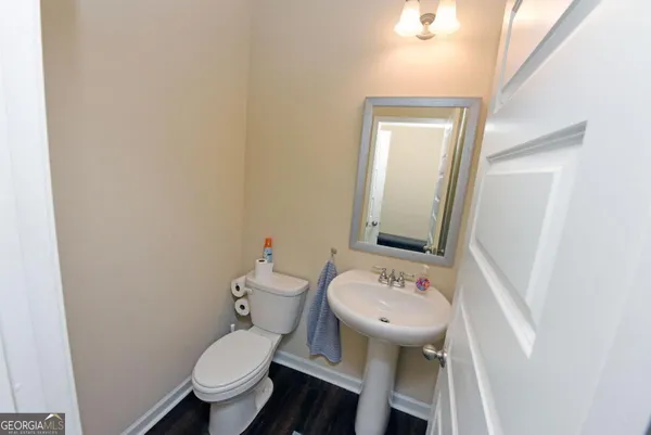 a bathroom with a sink toilet and mirror