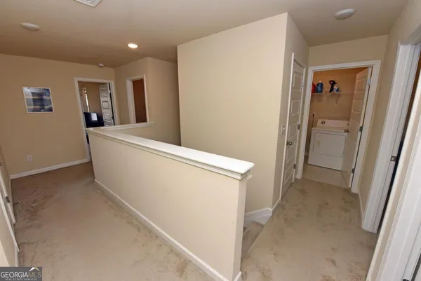 a view of hallway with bathroom