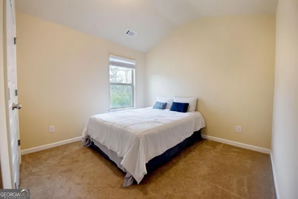 a bedroom with a bed and window