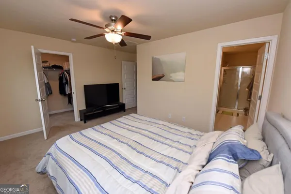 a bedroom with a bed and a television