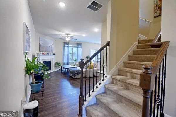 a view of entryway and hall with wooden floor