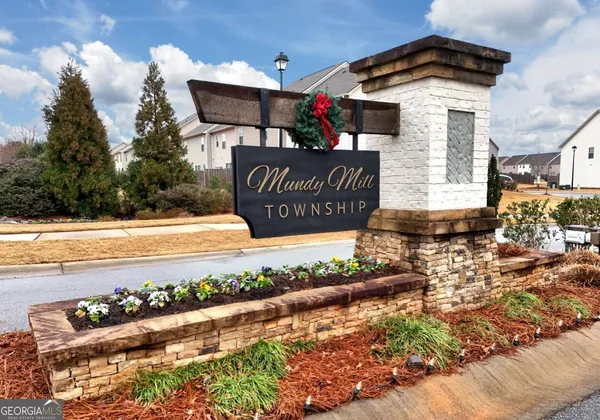 a front view of a house with a yard and a fountain
