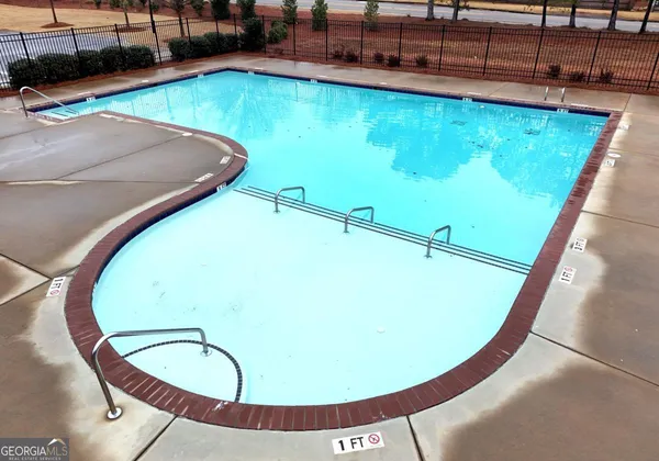 a view of a swimming pool with a chairs